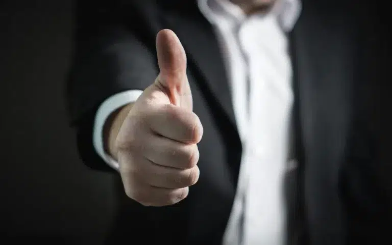 CLose up of a man doing a thumbs up gesture