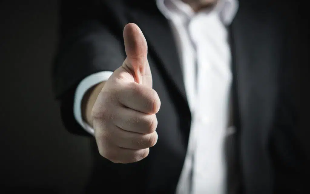 CLose up of a man doing a thumbs up gesture